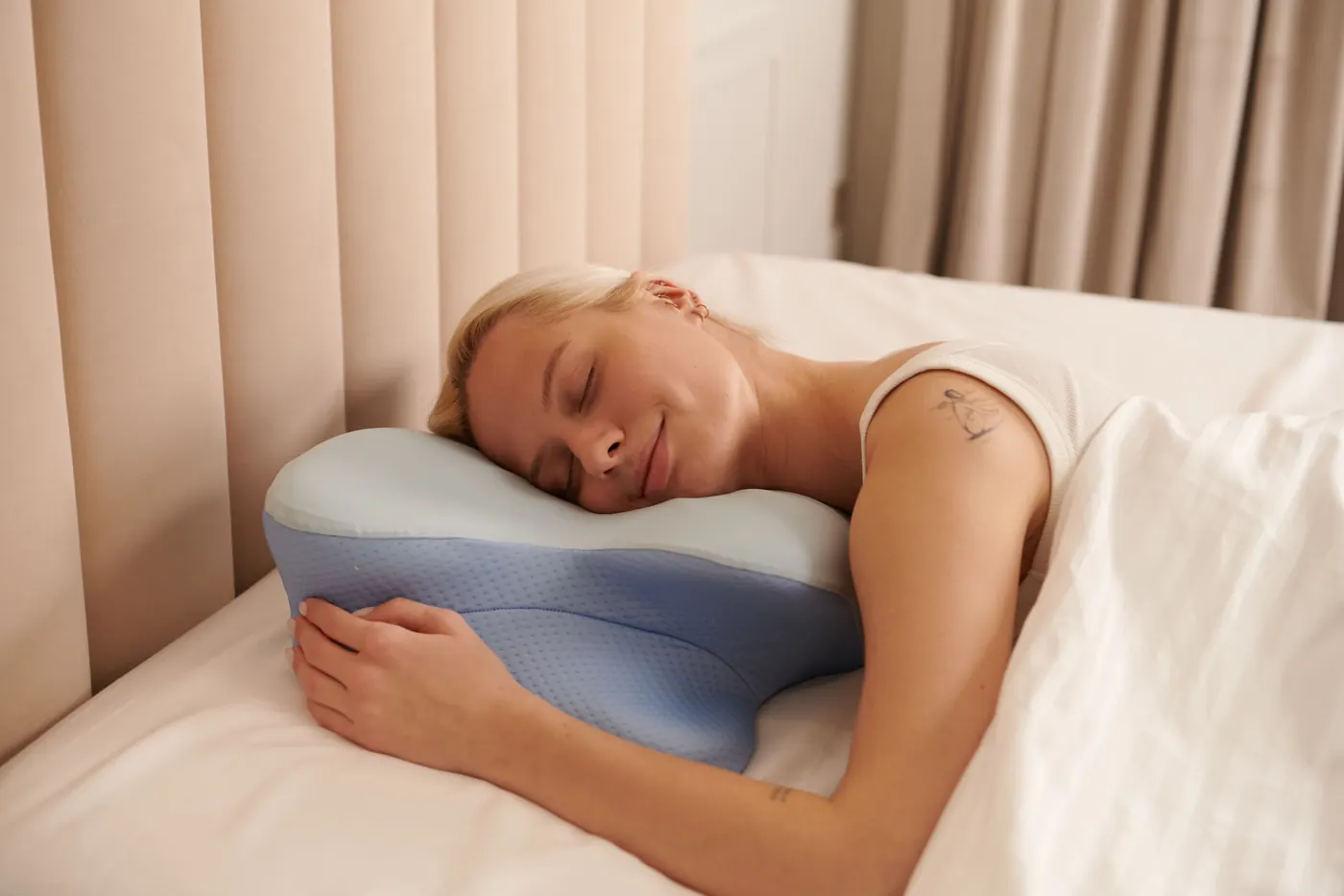 Lifestyle photograph of a person resting on a contoured pillow